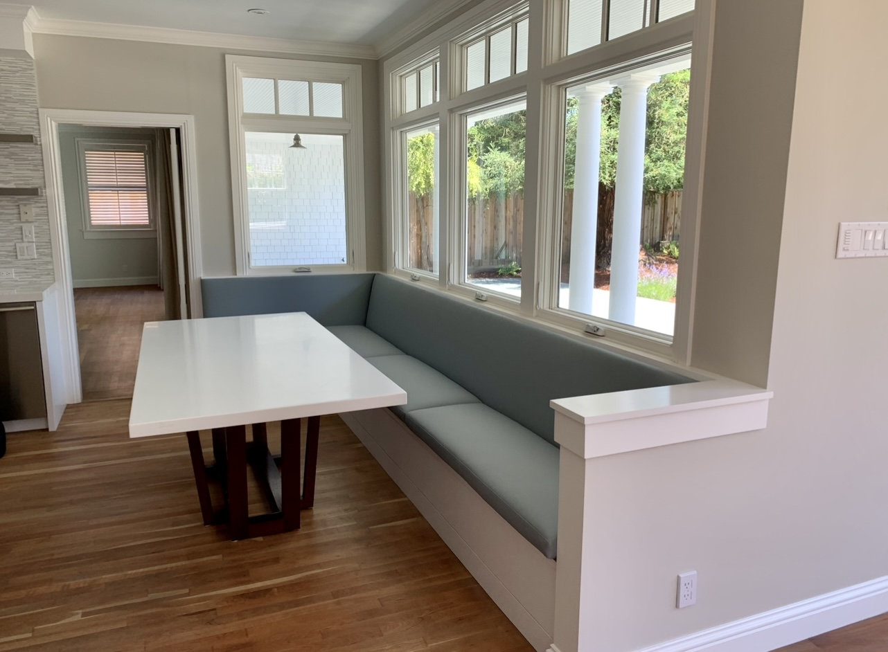 A dining room with a table and bench