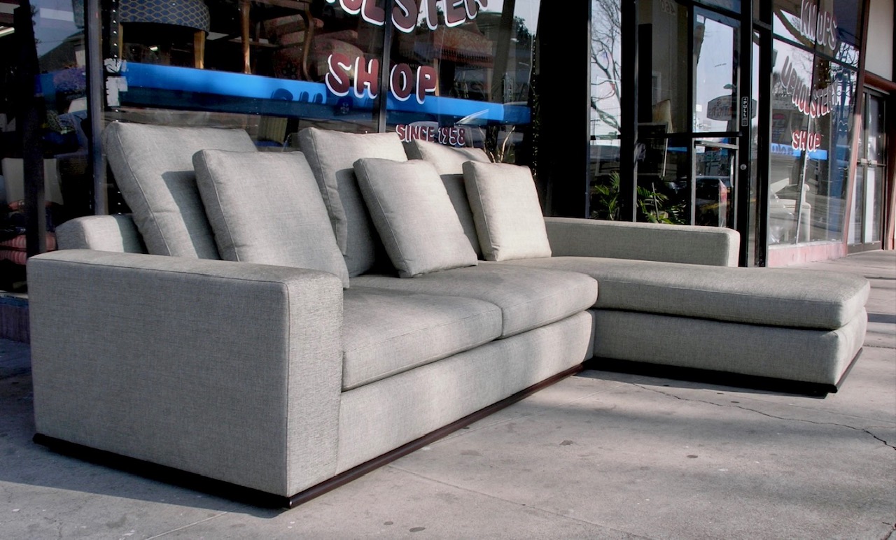 A couch sitting on top of a cement floor.